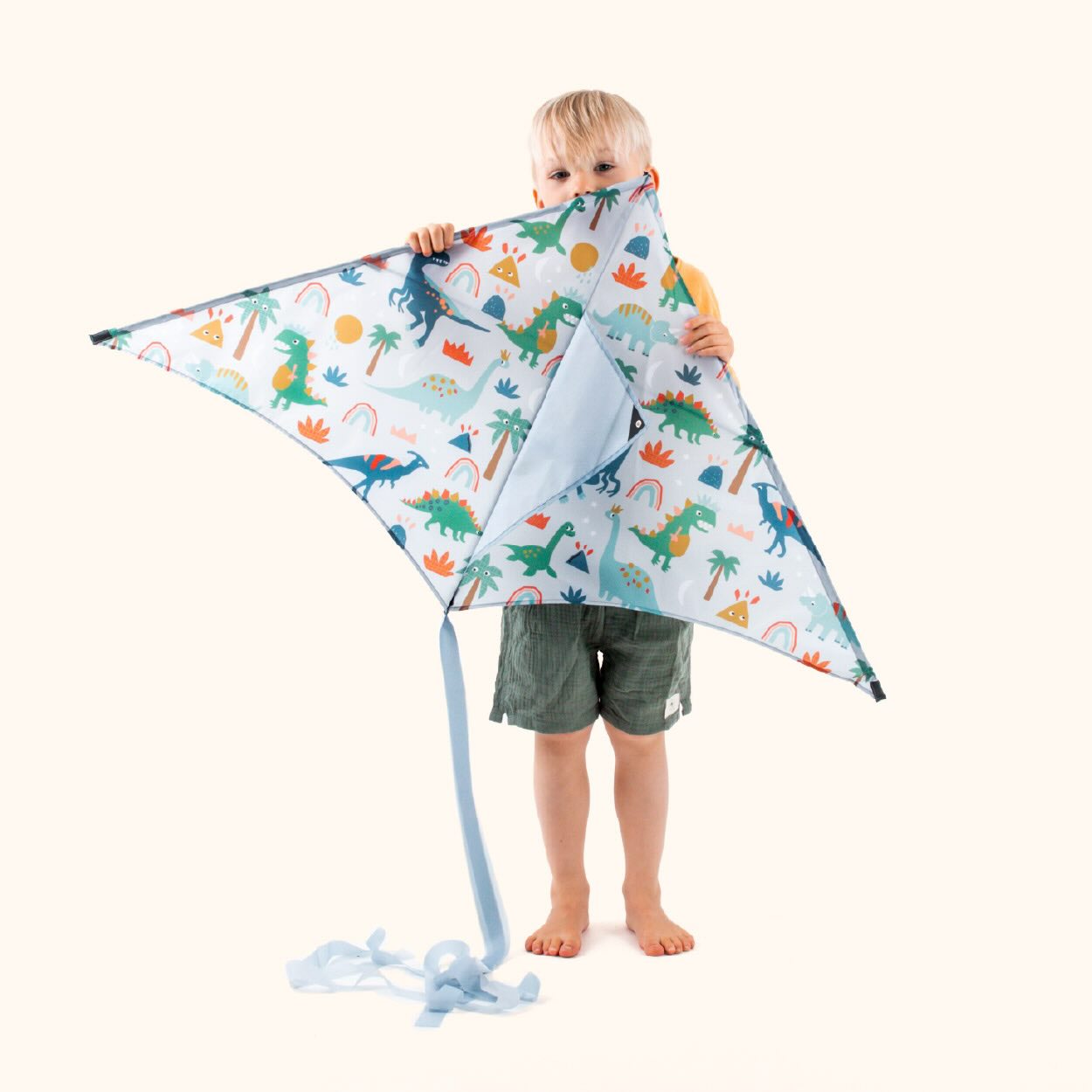 Boy playing with Dino Danger kite