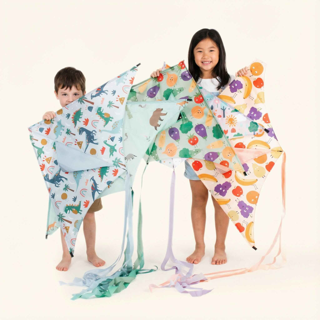 A boy and girl standing with their kites