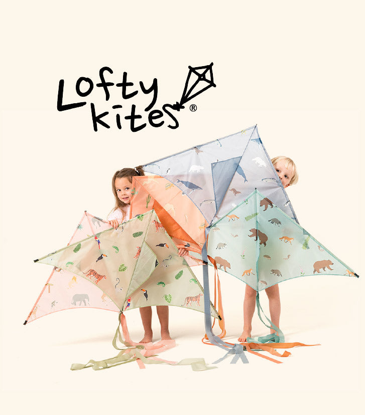 Two children playing with colourful Lofty kites on a white background